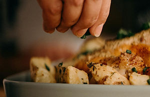 Close-up of dish being garnished