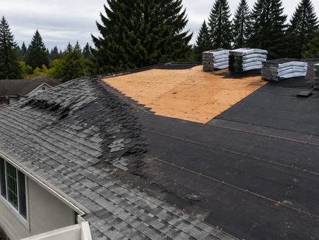 Full roof replacement often involves removing old shingles, exposing the roof deck, and installing new underlayment before new shingles are applied.