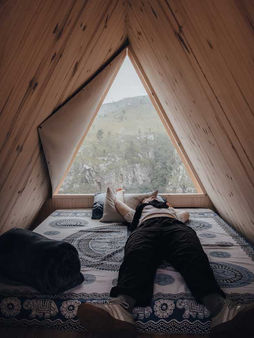 Man relaxing inside Tsitsikamma overnight hut