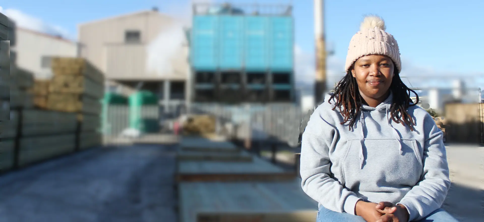 MTO Employee sitting in front of sawmill.