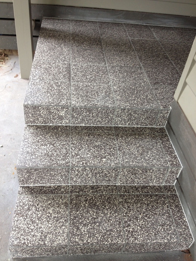 Tiled outdoor porch and steps.