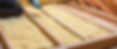 person laying batten insulation into the attic floor rafters.jpg
