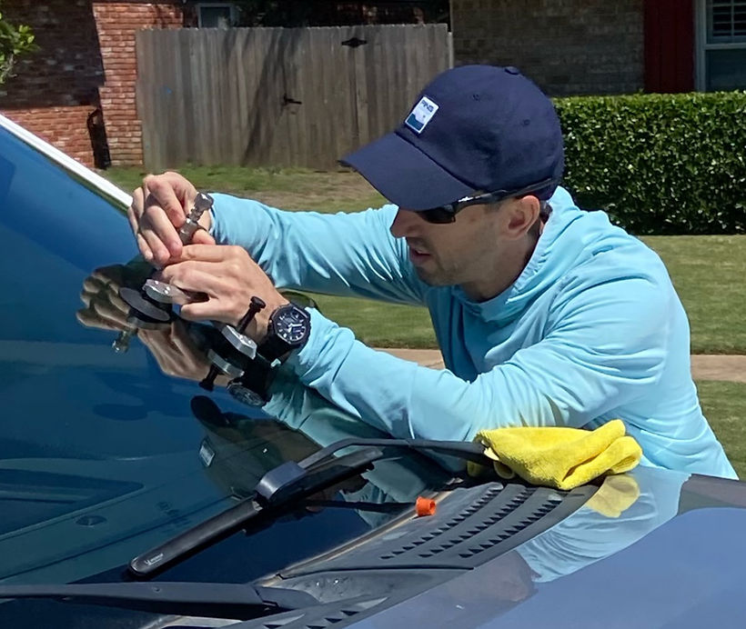 Technician performing windshield repair in Edmond Oklahoma