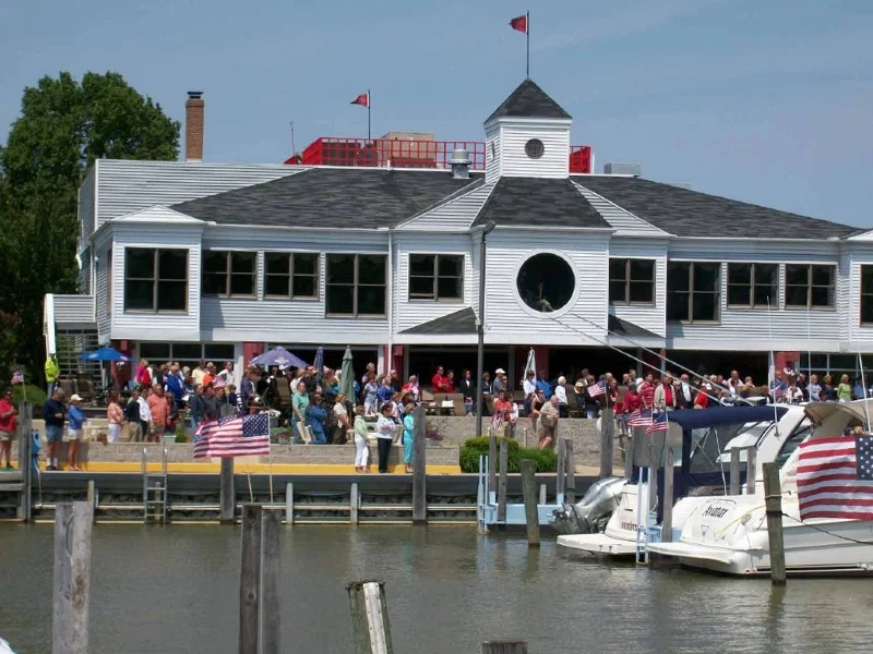 HYCwithPeopleBoatAndFlag.webp