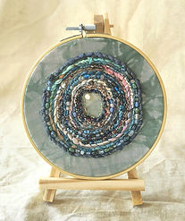 Circular abstract textile art in 6 inch natural wood embroidery hoop.
