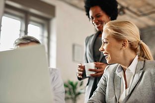 happy-mid-adult-businesswoman-talking-her-coworkers-laughing-while-working-office.jpeg