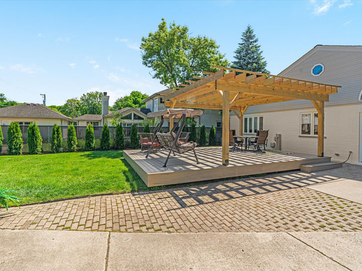 Custom wood pergola built over composite deck in Glenview 