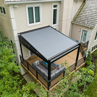 Custom motorized pergola over backyard patio