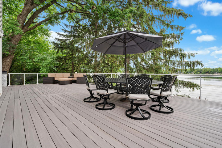 Custom outdoor kitchen with marble countertop, grill appliances, drawers, and stone finish built by OnDeck in Grayslake IL