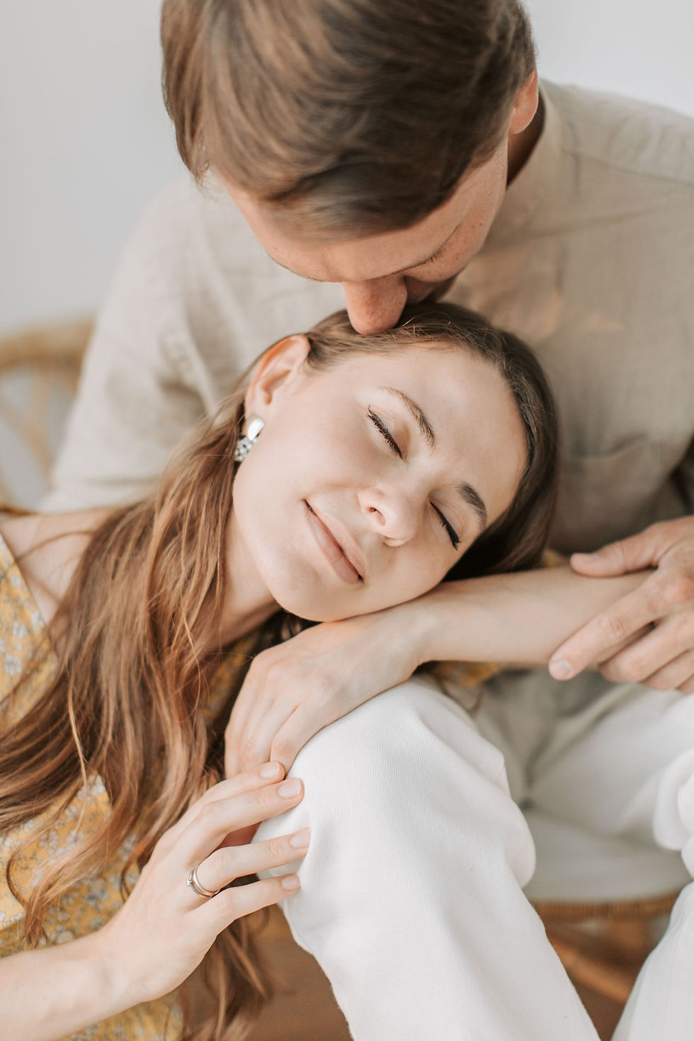 A loving couple shares a tender moment indoors, reflecting warmth and affection.