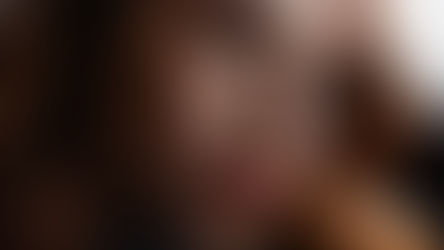 Close-up portrait of a pensive woman gazing out a window, reflecting deep thoughts and emotions.