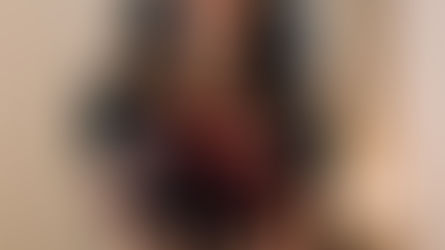 Blurred woman presenting a vivid red apple in focus, adding mystery.
