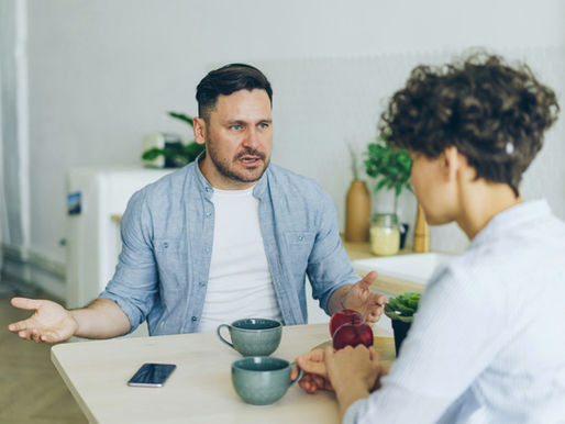 Annoyed man yelling at unhappy wife in kitchen fighting gesturing