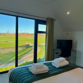 bed looking out to a field through a window