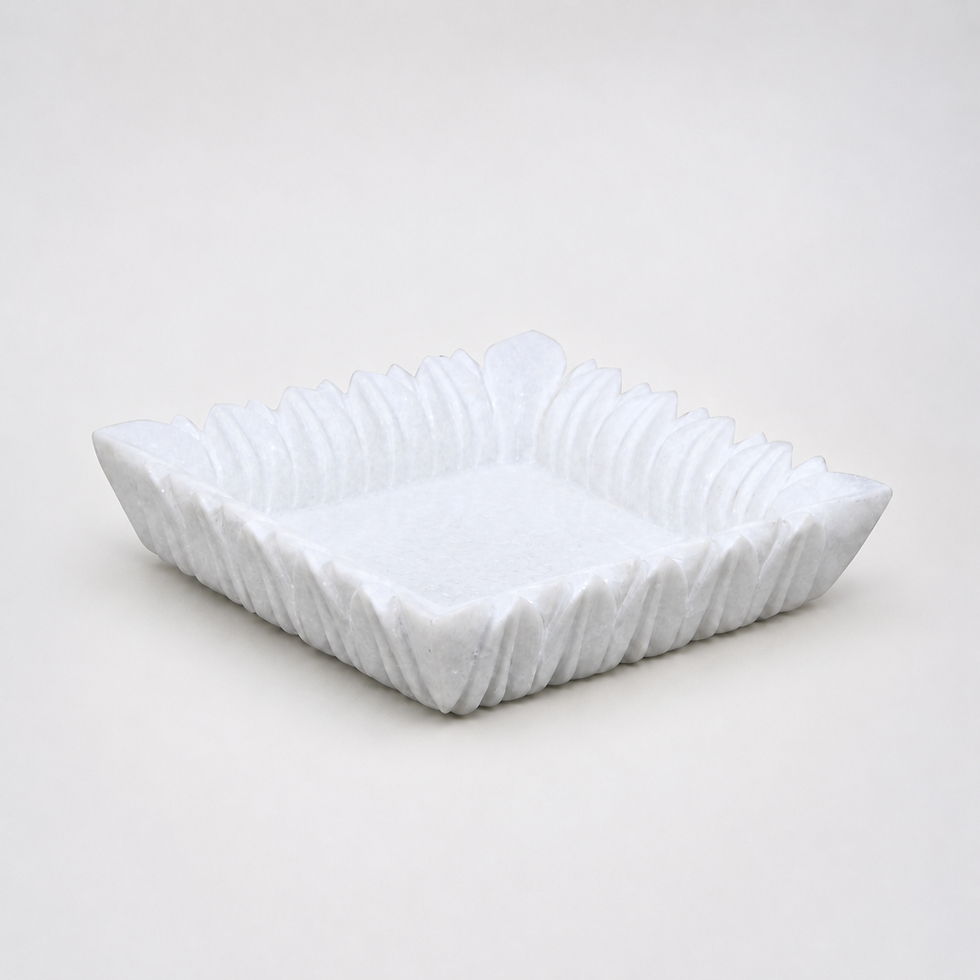 Nagar white granite vessel with scalloped carved edge on neutral studio background