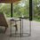 Thumbnail: Matte black iron nesting tables on a modern covered terrace with lounge chair