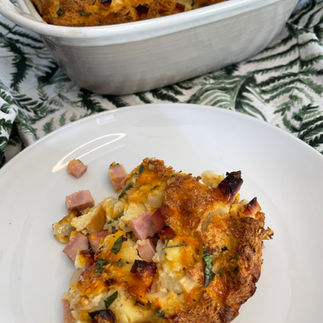 Close up image of cooked egg strata recipe on a white plate