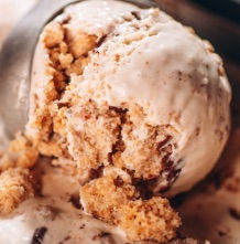 closeup of toasted marshmallow ice cream with swirls of chocolate ganache and   chunks of graham cracker clusters