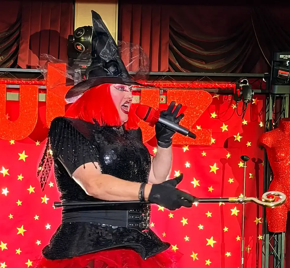 Drag performer singing on stage at Rubyz Cabaret in Bournemouth