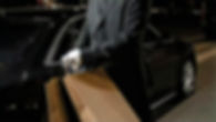 personal-driver-opening-car-door-for-vip-client-carrying-shopping-bags-in-city-4026234-hig