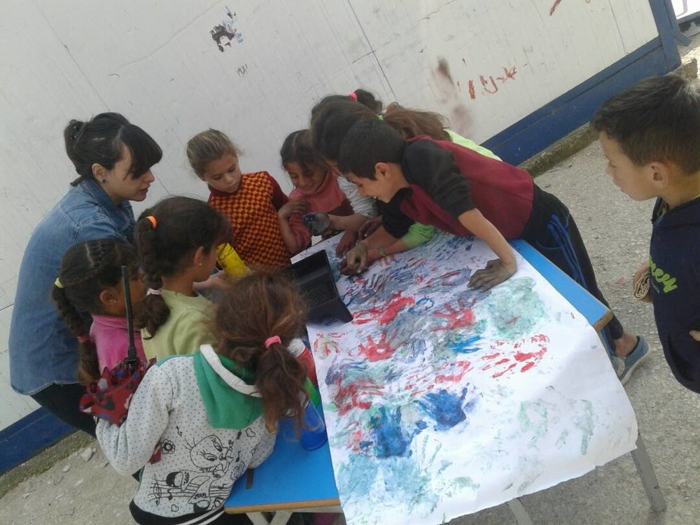 Child gather around a table for crafts