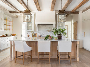 Custom-built modern farmhouse kitchen in Texas Hill Country with exposed wood beams, white cabinetry, and a large island – Vick Pope Custom Homes