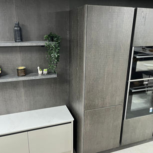 Modern handleless kitchen finished in a stunning timber slab door and taupe matt door