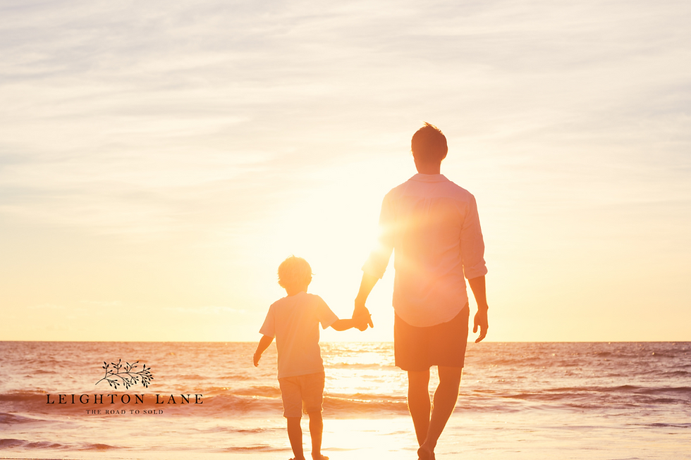 father and son walking on beach