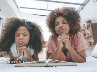 mom and daughter praying
