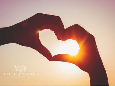 hands making a heart in the sunshine