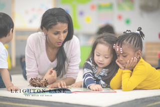 teacher with children at a desk