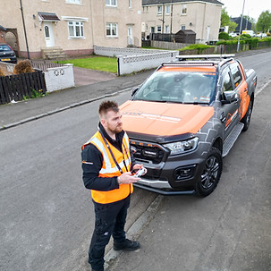 JDN property staff member with documents outside vehicle