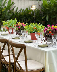 draped archway adorned with fresh flowers, lanterns, and greenery, 