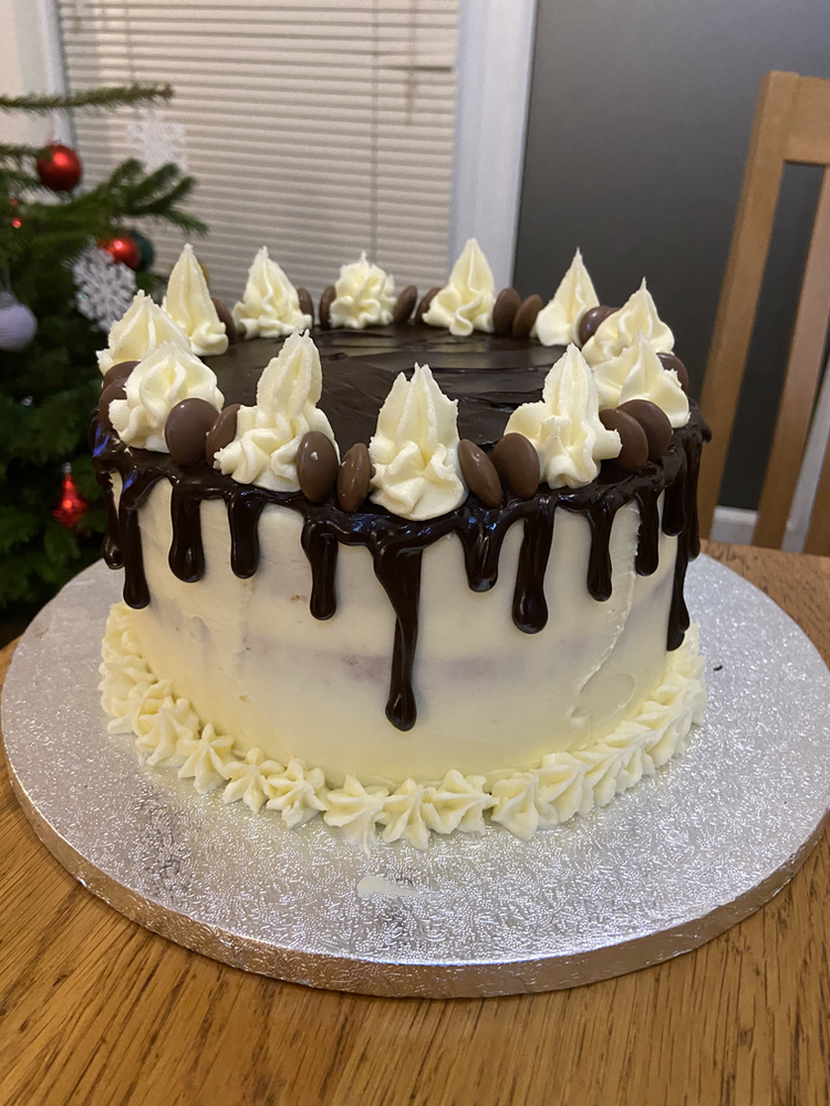 Vanilla birthday cake with strawberry jam & vanilla buttercream filling and a chocolate drip layer