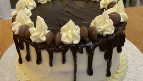 Vanilla birthday cake with strawberry jam & vanilla buttercream filling and a chocolate drip layer