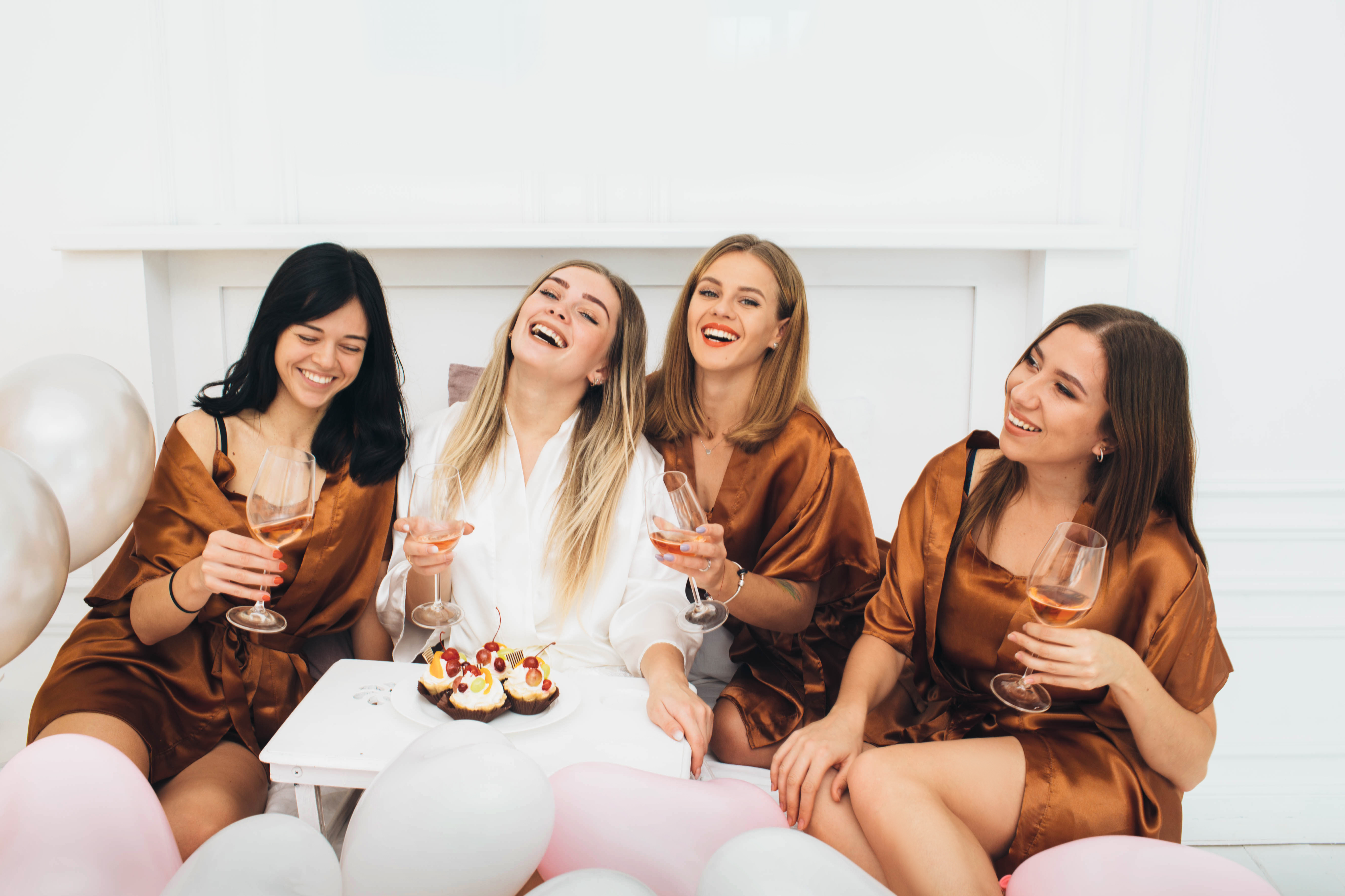 four-smiling-women-celebrating-with-cake-and-wine-2026-01-08-23-31-03-utc.jpg