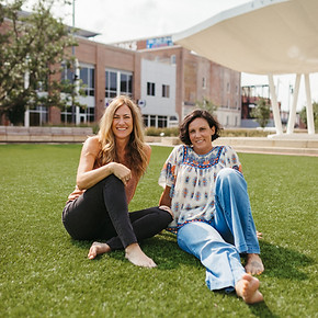 two women sitting at the park
