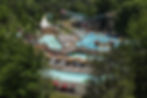 n aerial shot capturing the water park and train at Land of Make Believe, with various water slides prominently featured in the background.