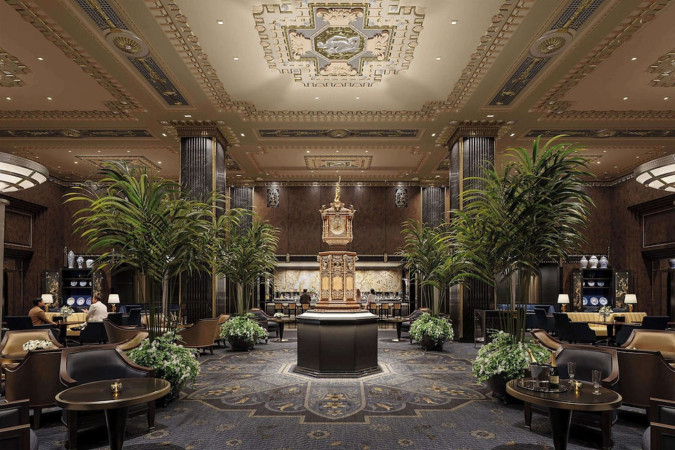 Elegant hotel lobby with ornate ceiling, central clock, column flanked by tall plants. People seated at tables, dim lighting, luxurious decor.