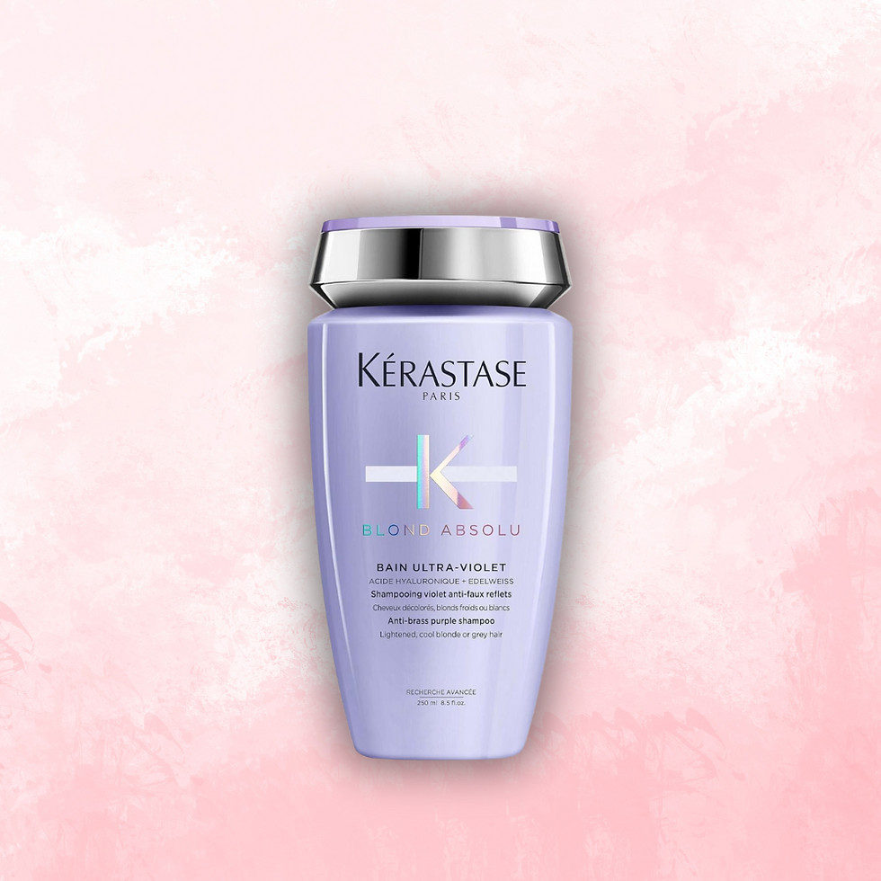 Lilac Kerastase Blond Absolu shampoo bottle with silver cap on a pink textured background. Text reads Bain Ultra-Violet.