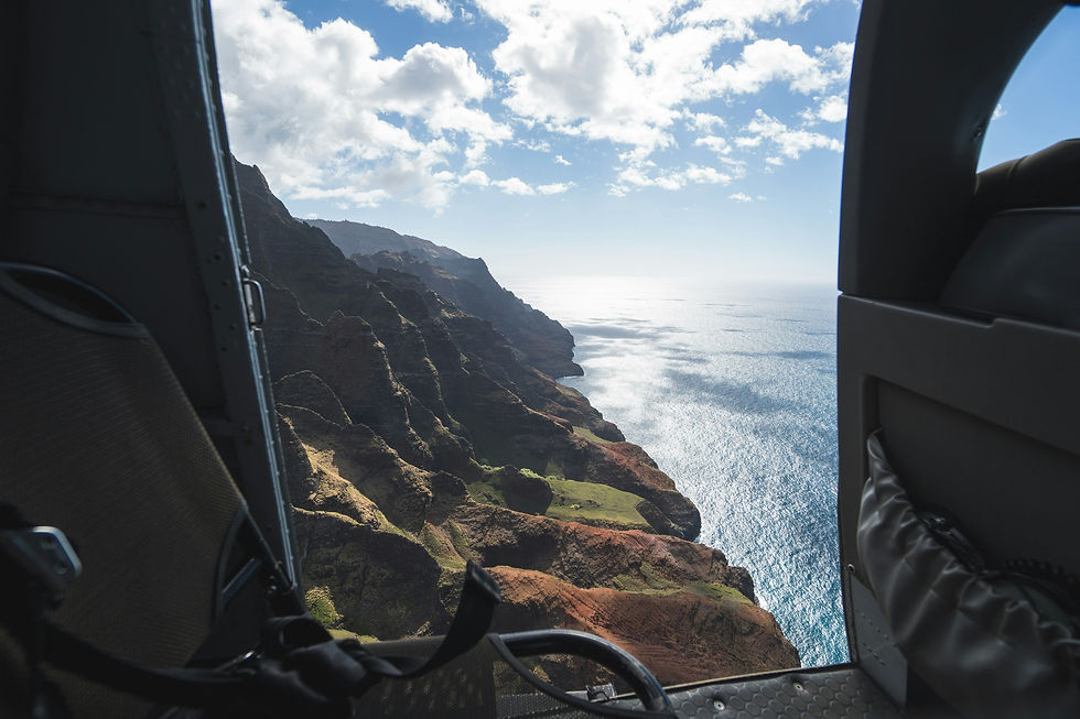 Aerial view of the jagged emerald spires and sea cliffs of the Na Pali Coast, Kauai, Hawaii, seen from a helicopter tou