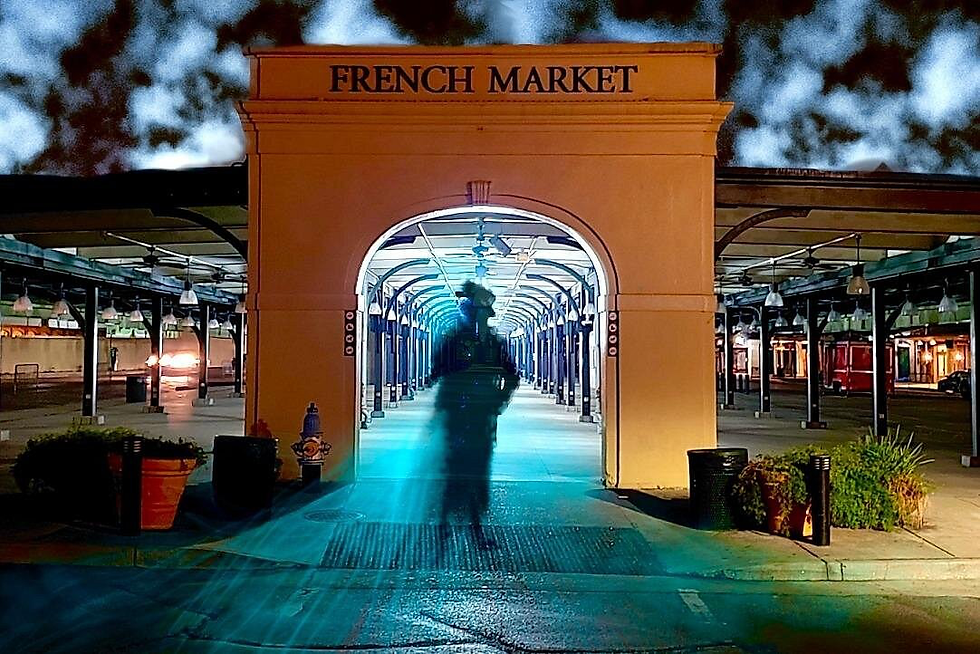 Nighttime French Market entrance with a blurred person silhouette under a blue-lit archway, empty stalls and warm lights.