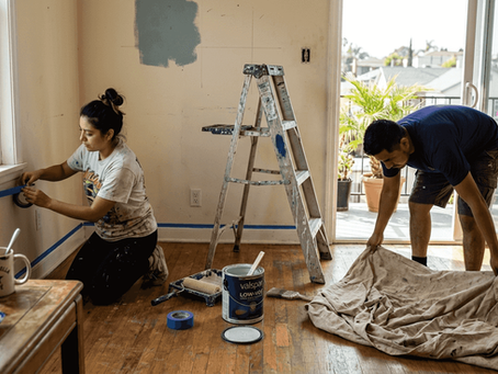 Couple preparing living room for painting project