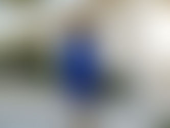 Homeowner evaluating weathered paint on LA home