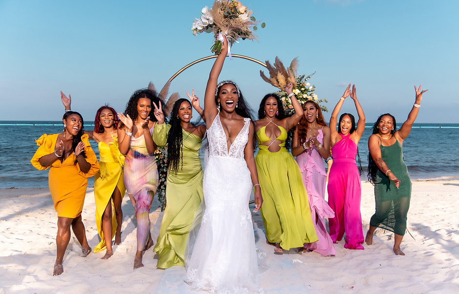 India and her bridesmaids in front of ceremonial wedding arch in Cacnun