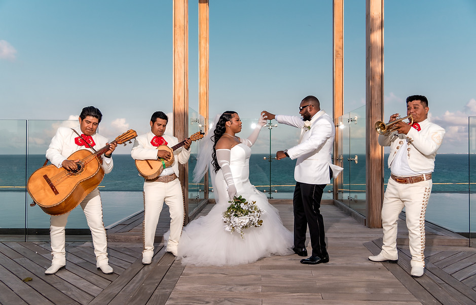 Briana and Jeff dancing with mariachis at their Cancun wedding