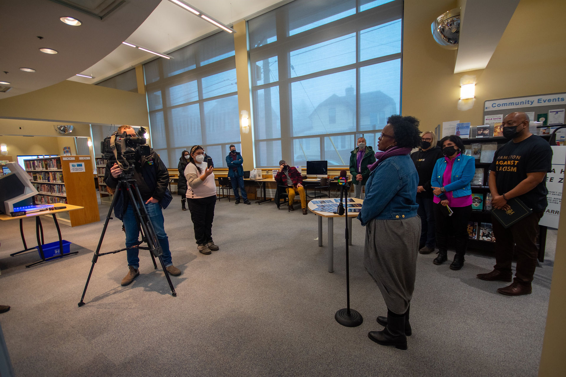 Evelyn Myrie speaks at the microphone during the community meeting.