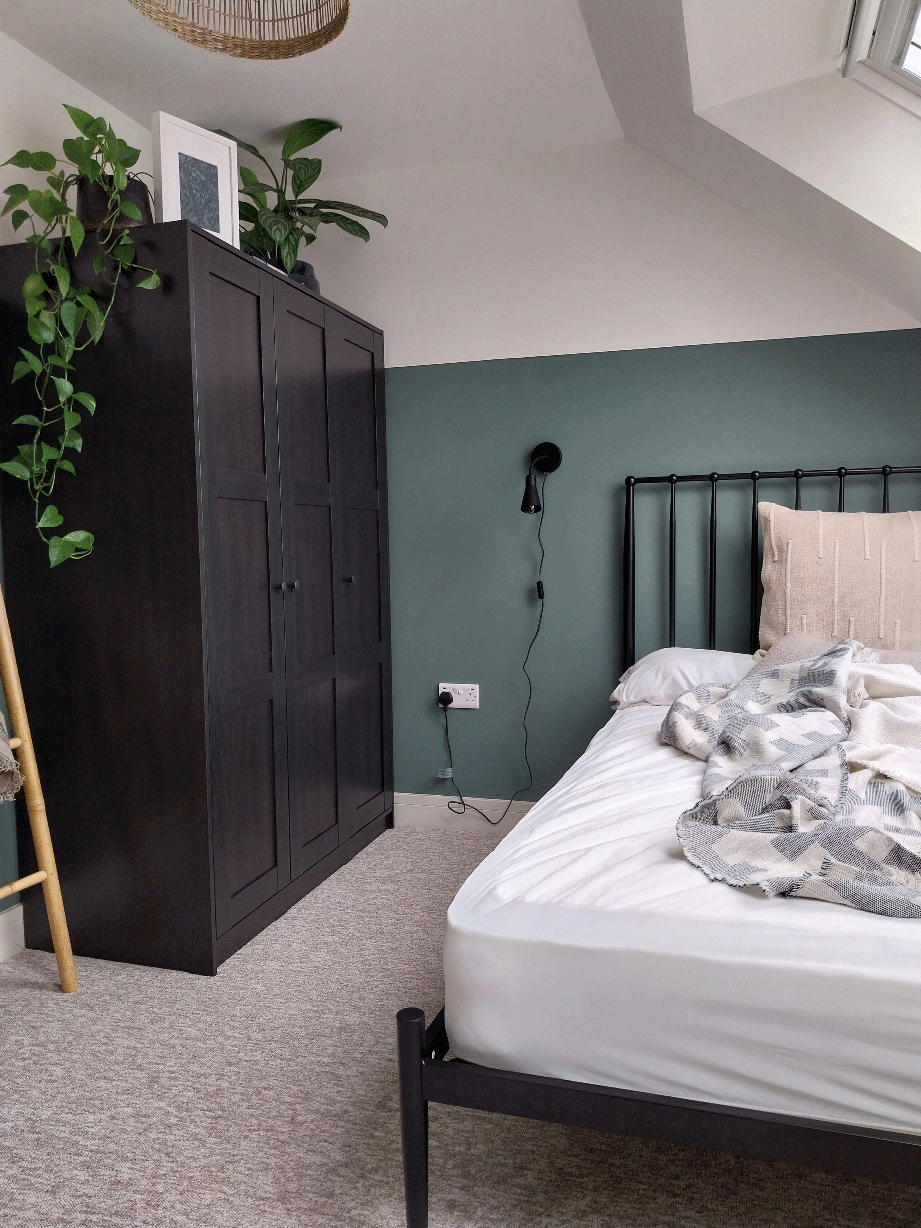 Black metal bedframe, black IKEA 3 door wardrobe, olive and white walls. HMO loft conversion in Henbury, Bristol