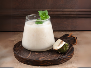 a glass of soursop margarita garnished with mint