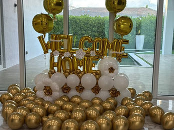 Gold and white Welcome Home balloon decoration by ABI DECOR Florida.